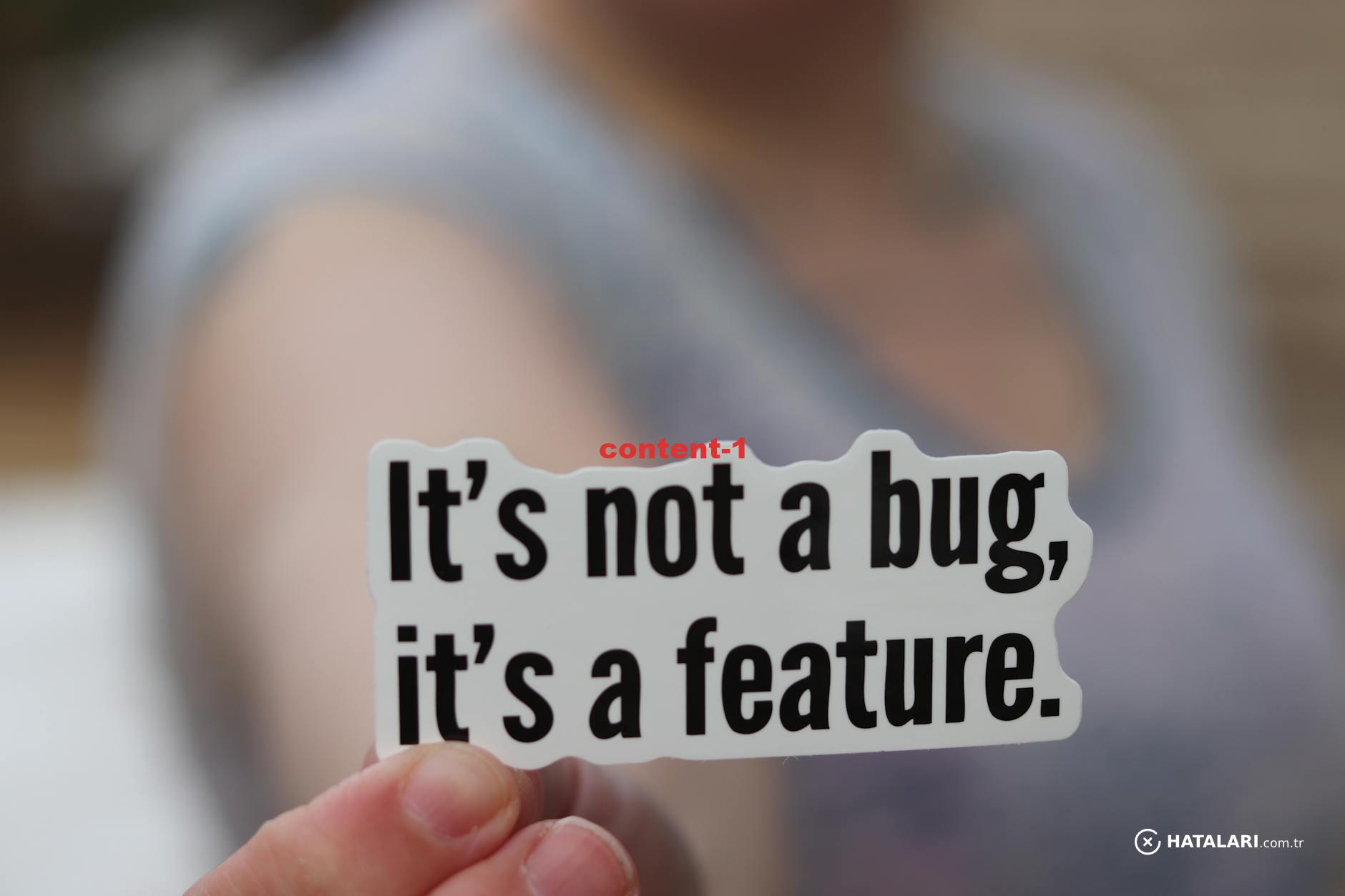Close-up of a hand holding a sticker with a humorous tech message:
