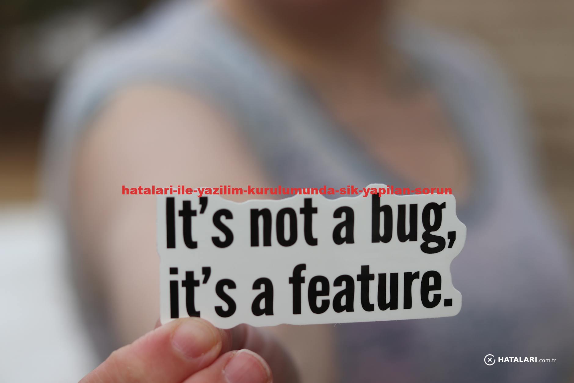 Close-up of a hand holding a sticker with a humorous tech message: