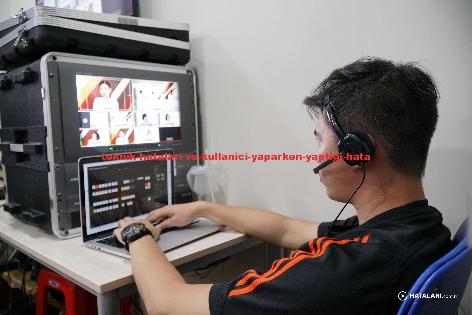 Technician manages multiple video feeds using laptop and monitor in studio setting.