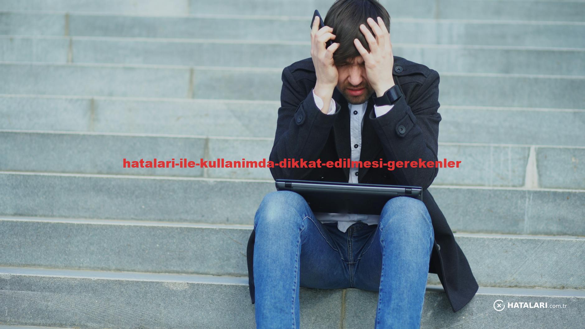 Man sitting on stairs with laptop, looking stressed and frustrated.