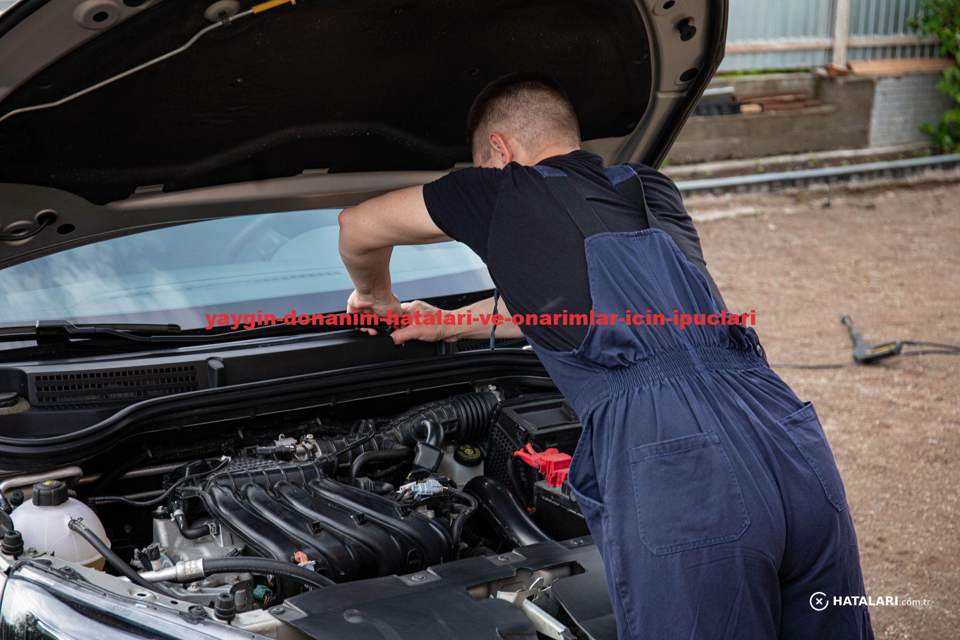 Mechanic fixing car engine outdoors, summer afternoon, skillful work.
